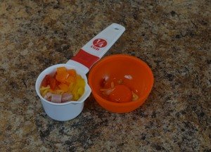 Raw_omlet_fixings_peppers_ham_cooked_eggs